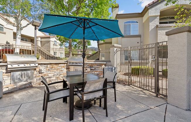 our patio has a table and chairs with an umbrella