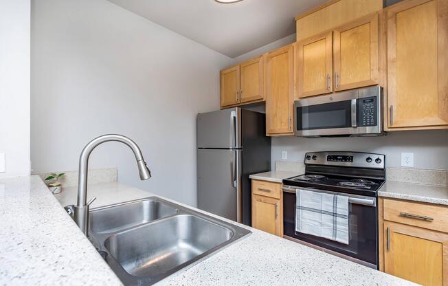 a kitchen with stainless steel appliances and wooden cabinets