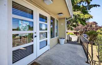A house entrance with a sign that says "Welcome, Please Come In".