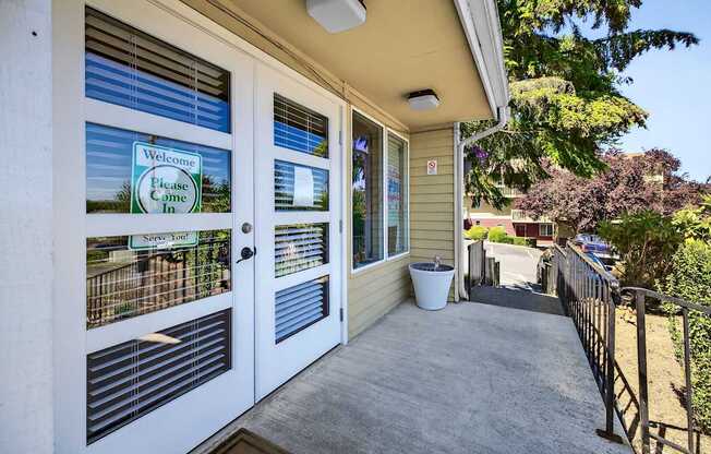 A house entrance with a sign that says "Welcome, Please Come In".