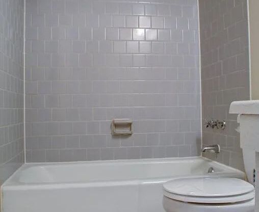 Tiled floor bathroom with subway tiled shower