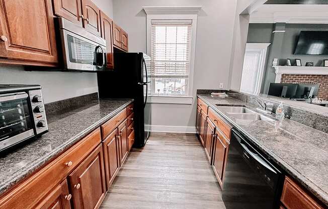 a kitchen with granite counter tops and wooden cabinets