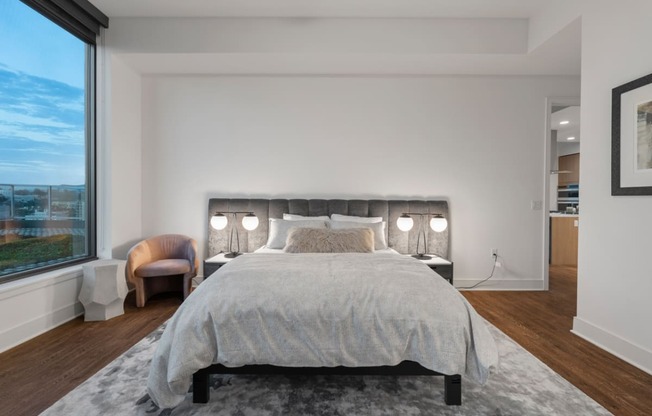 a bedroom with a large bed and a large window  at Stanza Little Italy, San Diego, CA, 92101