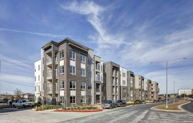 a row of apartment buildings on a city street at Arise Riverside, Austin Texas