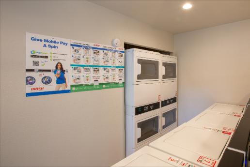 A poster on the wall says "Give Mobile Pay a Spin".