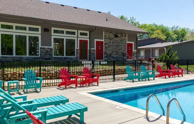 Old Hickory Lake Apartments - Retreat at Indian Lake - Enclosed Outdoor Pool Surrounded By Red and Blue Lounge Chairs