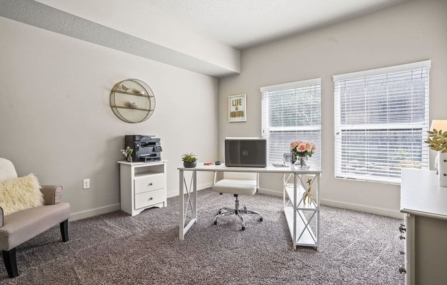 our apartments have an office with a desk and chair and a window