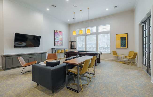 a lounge area with a table and chairs and a television