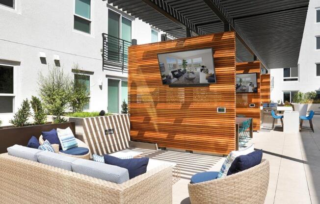 a patio with furniture and a television