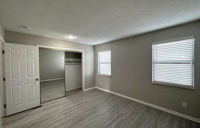 an empty living room with a large window