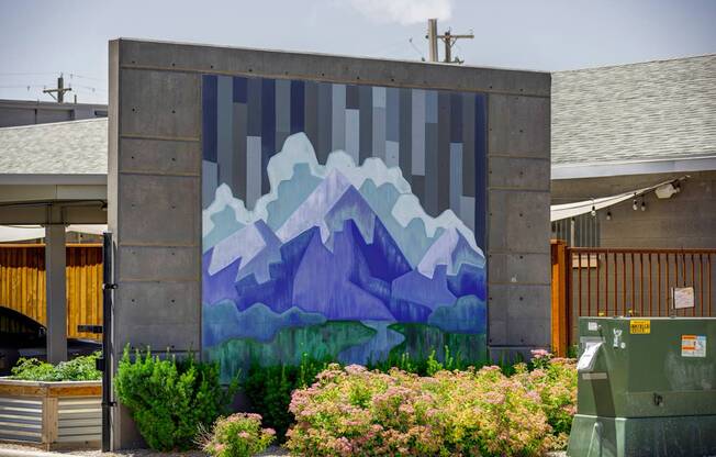 A mural of mountains painted on a wall.