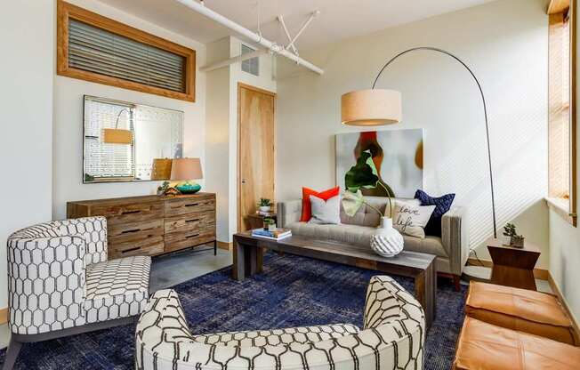 A living room with a patterned chair and a patterned ottoman.
