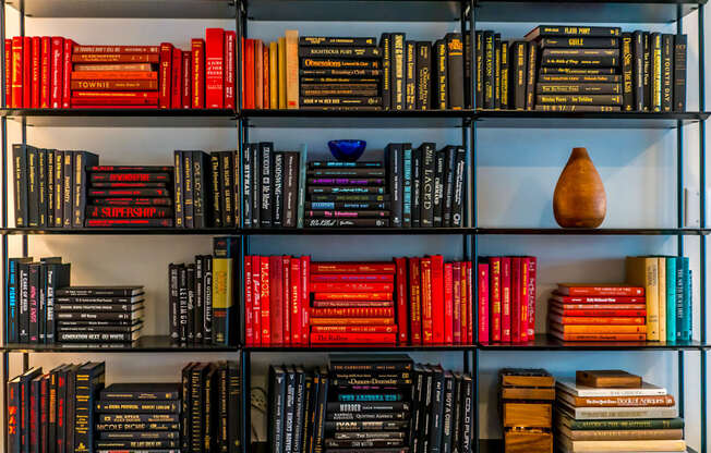 A bookshelf filled with books of various colors and sizes.