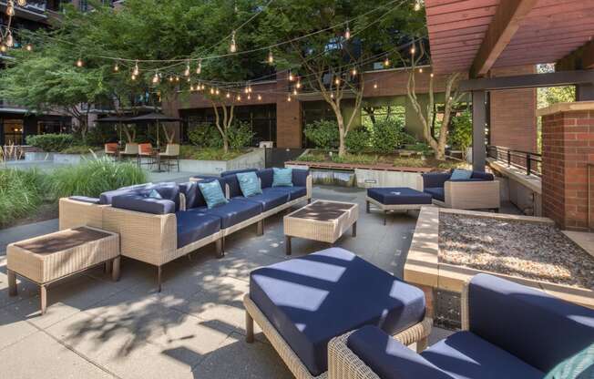 a patio with couches and chairs and a fire pit