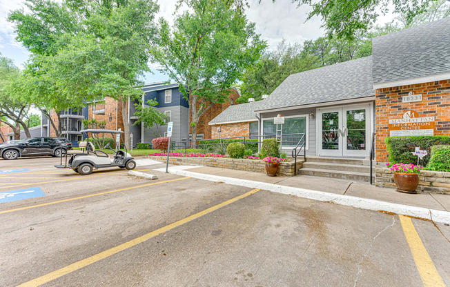 A parking lot with a building and a golf cart.
