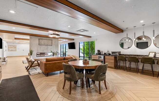 a living room with a table and chairs and a kitchen