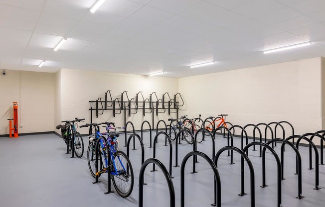 A bike parking area with many bikes parked.