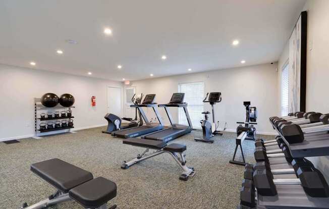 a gym with treadmills and other exercise equipment at Station JTown, Louisville, KY