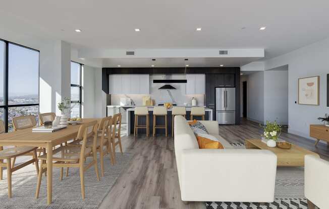 a living and dining room area with a table and chairs