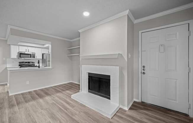 a living room with a fireplace and a white door