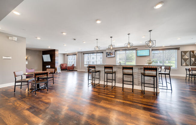 a large living room with a bar and a dining room