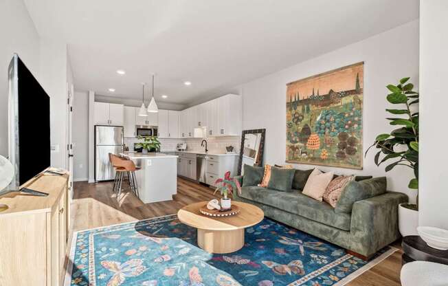 A living room with a couch, a coffee table, and a television.