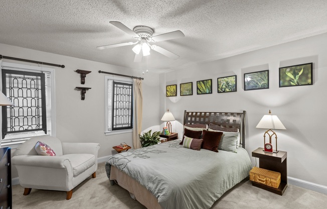 a bedroom with a large bed and a ceiling fan