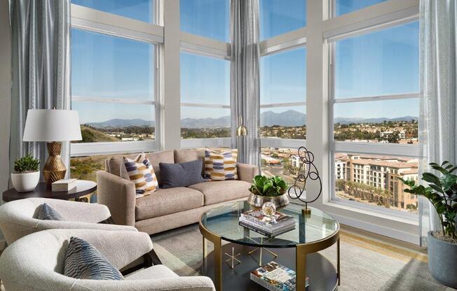 a living room with a view of a city and a large window