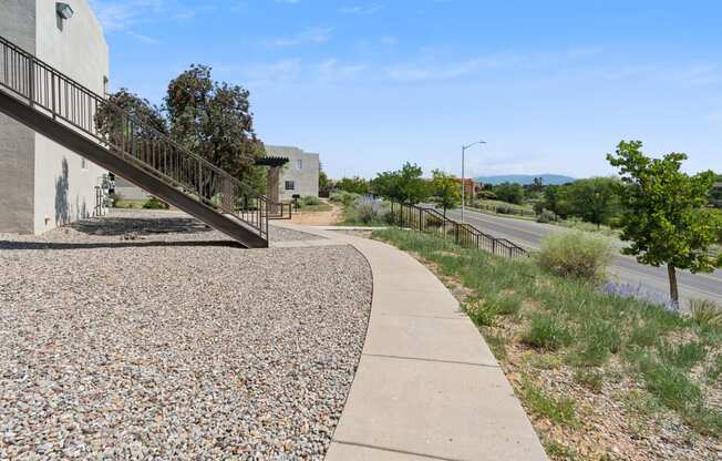 a walkway next to a building and a street