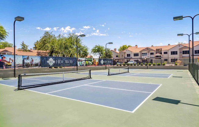 A tennis court with a sign that says