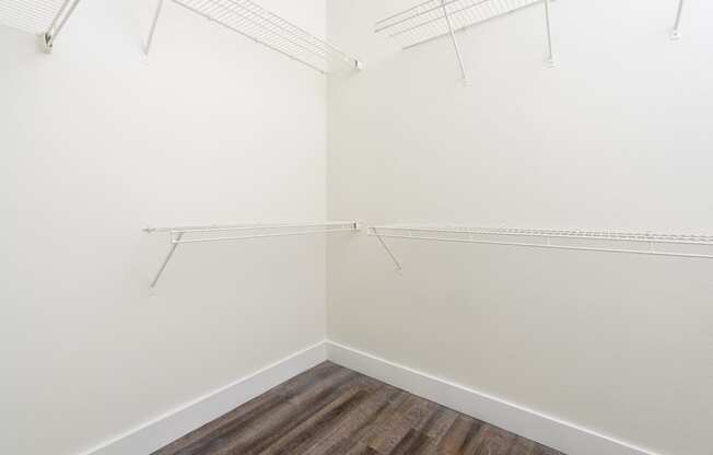 a walk in closet with shelves