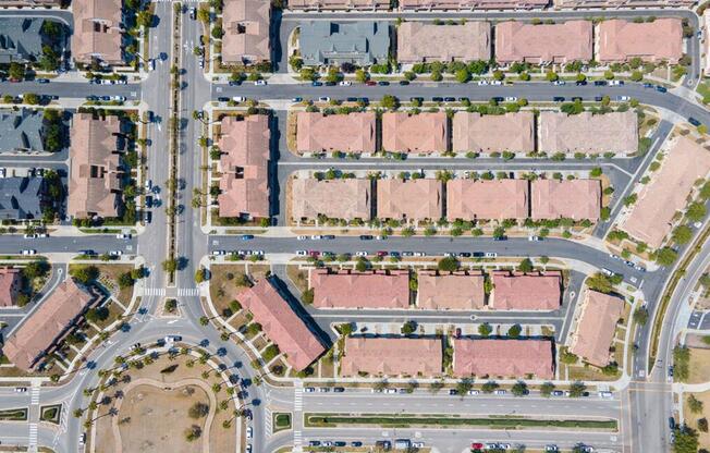 a birdseye view of a street intersection with cars and houses at The Vines at Riverpark, LLC, Oxnard