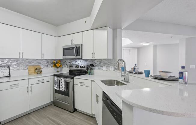 a kitchen with white cabinets and stainless steel appliances at Pembroke Pines Landings, Pembroke Pines 