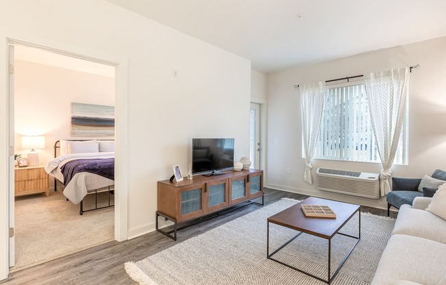 a living room with a couch and a coffee table and a tv