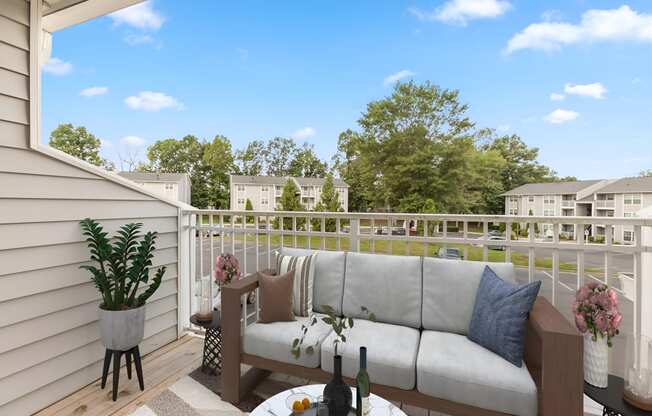 a patio with a couch and a table on a balcony