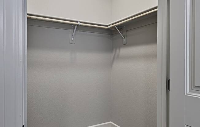 an empty basement with a closet and a light on the ceiling