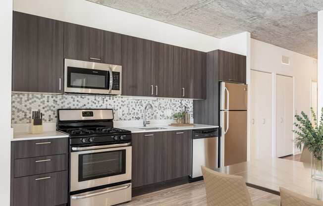 a kitchen with stainless steel appliances and wooden cabinets at One 333, Chicago, Illinois, 60605
