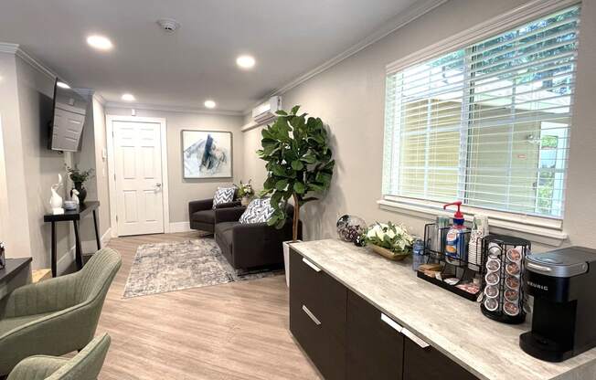 a living room with a couch and a counter with a coffee machine