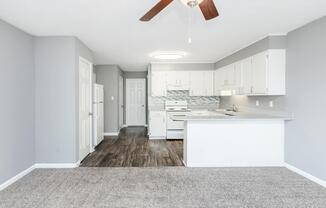a kitchen area with a building in the background
