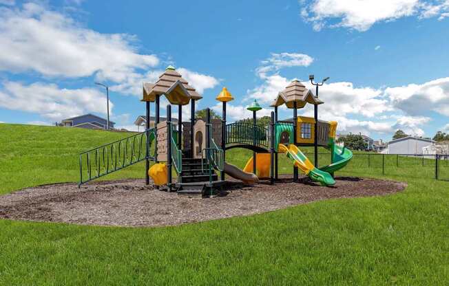 a playground with a slide and other toys in a park at The Lorient Apartments, Florida, 32514