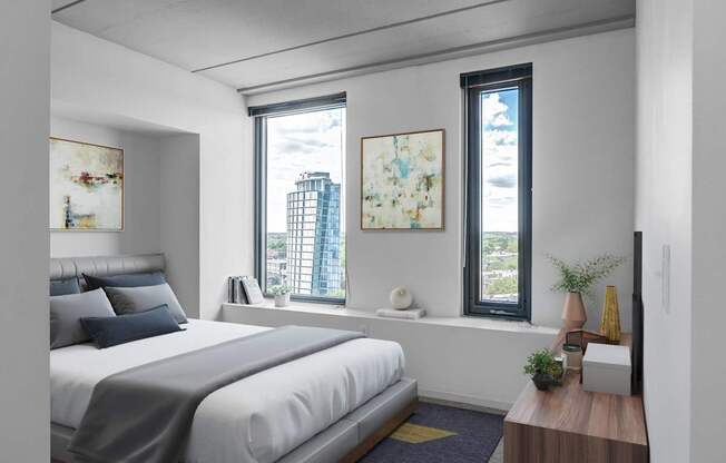 A bedroom with a large bed and a window overlooking a cityscape.