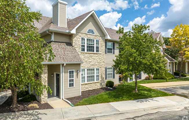 A house with a grey roof and a white chimney.