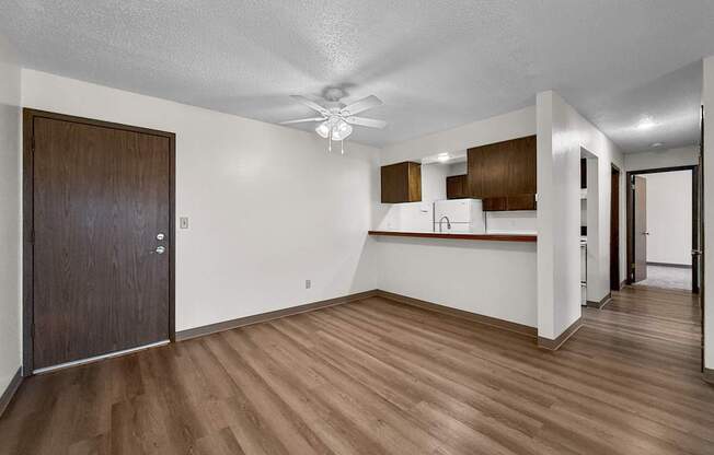 A room with wooden floors and a brown door.