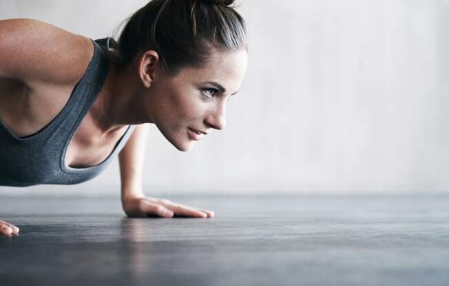 a woman is doing a plank on the floor