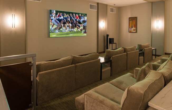 a living room with couches and a tv on the wall