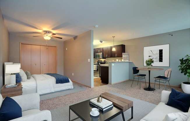 a living room and kitchen with a couch and a table. Fargo, ND Urban Plains Apartments