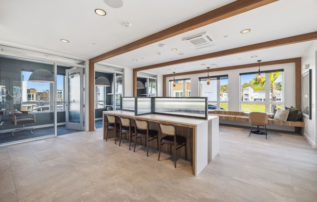 a large kitchen with a bar and chairs in front of it