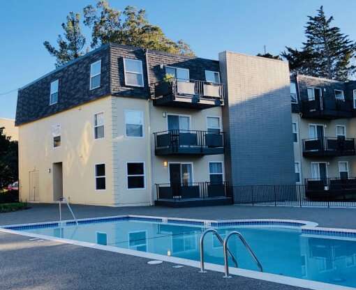 a building with a swimming pool in front of it