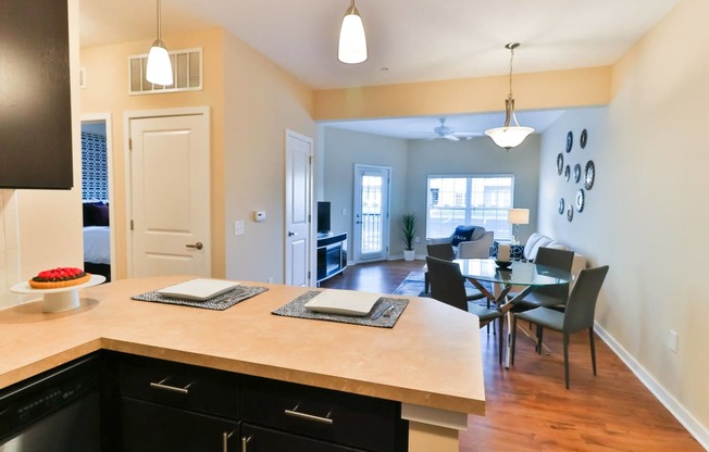 a kitchen and dining area with a table and chairs and a large counter top