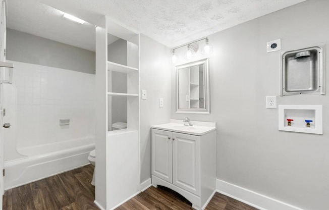 a bathroom with a sink and a shower and a mirror